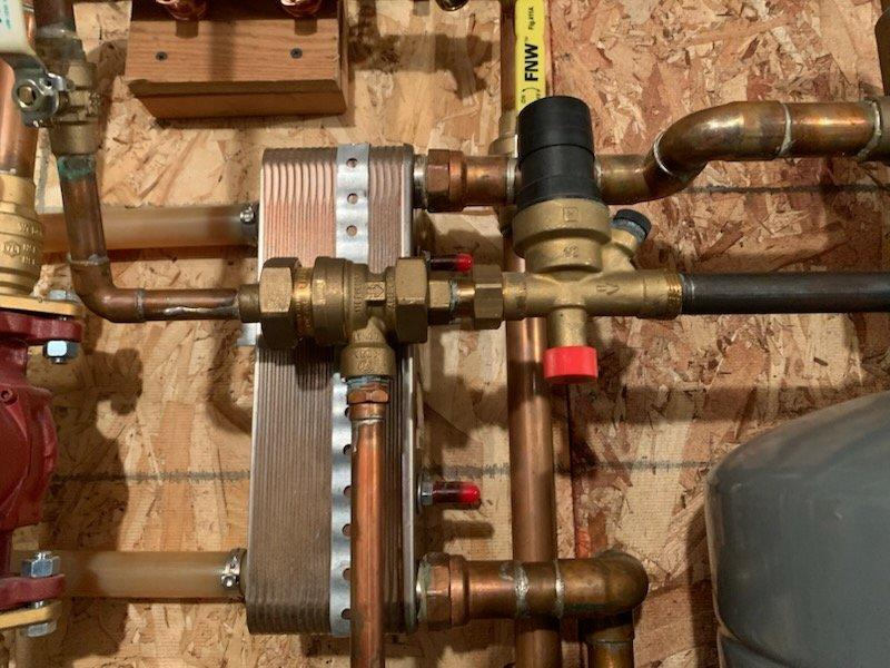 Responded to service call for boiler system with reported backflow preventer leak. Inspected the hydronic heating system, which included copper piping, plate heat exchanger, expansion tank, and circulation pumps. Successfully stopped the active leak on the backflow prevention device through temporary measures. Advised customer that while the immediate leak has been addressed, the backflow preventer will require complete replacement if the leak recurs.