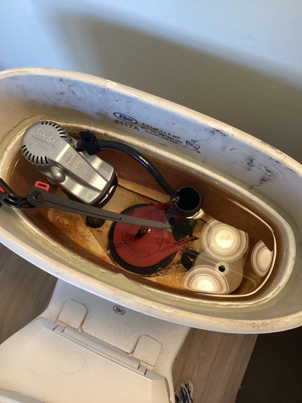 Performed comprehensive plumbing inspection of bathroom fixtures. Examined bathroom sink, faucet, and drain for proper functionality with no visible leaks detected. Inspected toilet tank internal components, noting significant mineral buildup and aging on Kohler float valve mechanism, flapper valve, and tank walls. Recommended descaling treatment and potential replacement of internal components to prevent future issues.
