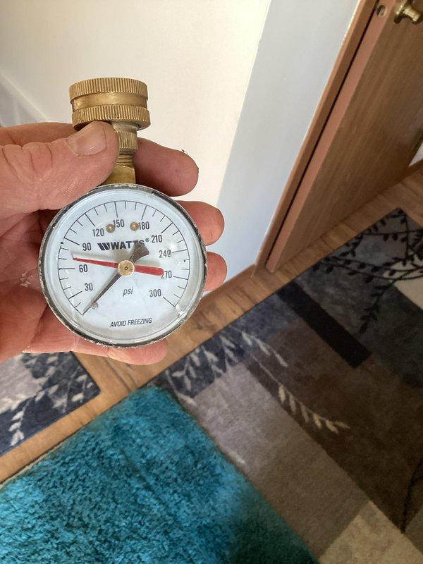 Installed water hammer arrestors on washing machine supply lines to address noise complaints. Pressure was verified at approximately 20-30 psi using a Watts gauge. Additionally, secured loose electrical wiring that was making contact with the washer unit, which was contributing to operational noise. Initial testing showed significant noise reduction.