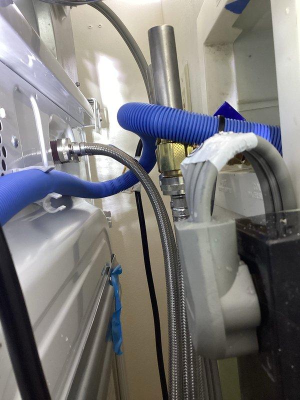 Installed water hammer arrestors on washing machine supply lines to address noise complaints. Pressure was verified at approximately 20-30 psi using a Watts gauge. Additionally, secured loose electrical wiring that was making contact with the washer unit, which was contributing to operational noise. Initial testing showed significant noise reduction.