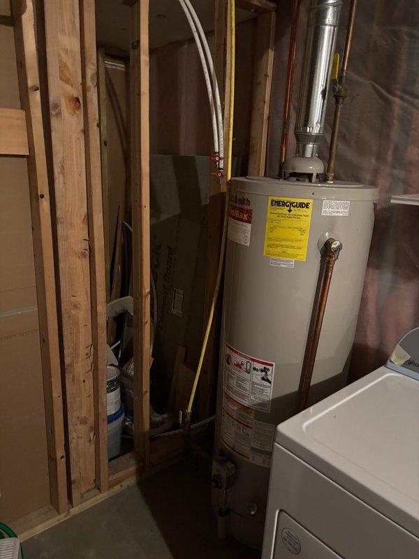 Completed replacement of a 27-year-old AO Smith 50-gallon natural gas water heater with a new unit. Took measurements to ensure proper fit in the utility area. Installation included connecting copper water lines and proper venting of the exhaust system through the existing vent pipe. All work was completed according to code requirements.