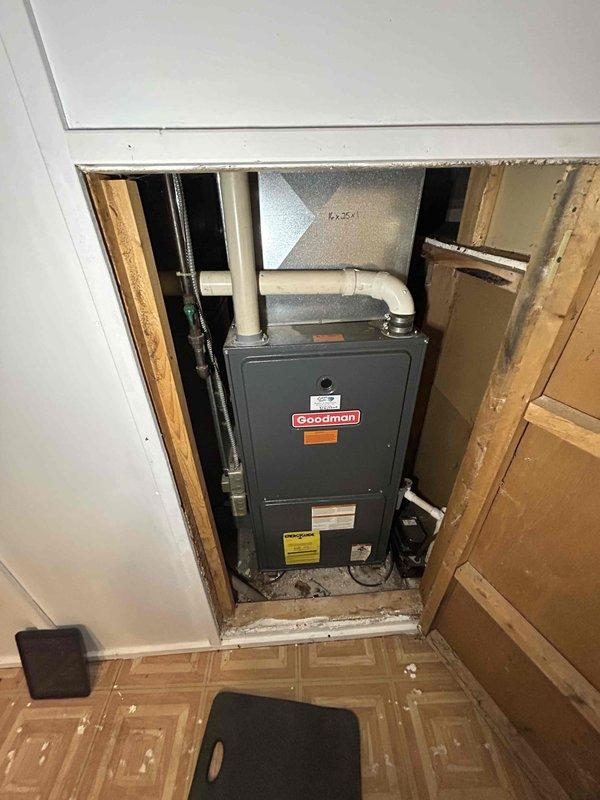 Responded to gas leak service call for Goodman furnace unit located in basement utility room. Upon inspection, identified leakage from gas valve through manifold and discovered significant breach in heat exchanger. Recommended immediate replacement of heat exchanger and gas valve due to safety concerns; scheduled service advisor to quote complete unit replacement.