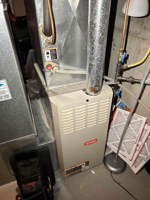 Performed tune-up on 23-year-old Bryant furnace, cleaning flame sensor, checking CO levels (safe), and verifying gas pressure within range. Observed wear on inducer motor and rust/corrosion on heat exchanger likely caused by condensate trap/drain issues. Recommended inducer motor repair, filter replacement every 2-3 months, and installation of carbon monoxide detectors on first and second floors.