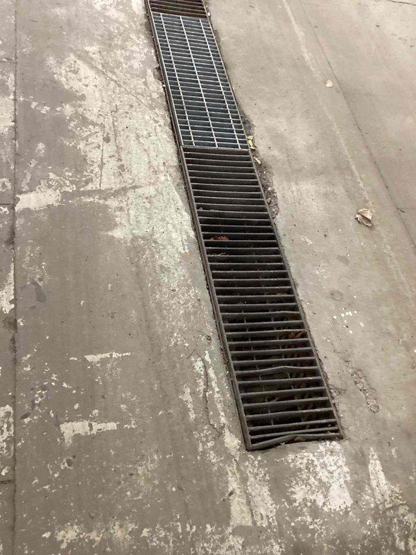 Responded to service call for clogged wash bay drainage system. Inspection revealed significant debris accumulation in the floor drainage grates, causing water backup across the concrete floor. Manually cleaned out all obstructed drainage channels, removing built-up sediment and debris to restore proper water flow and drainage functionality.