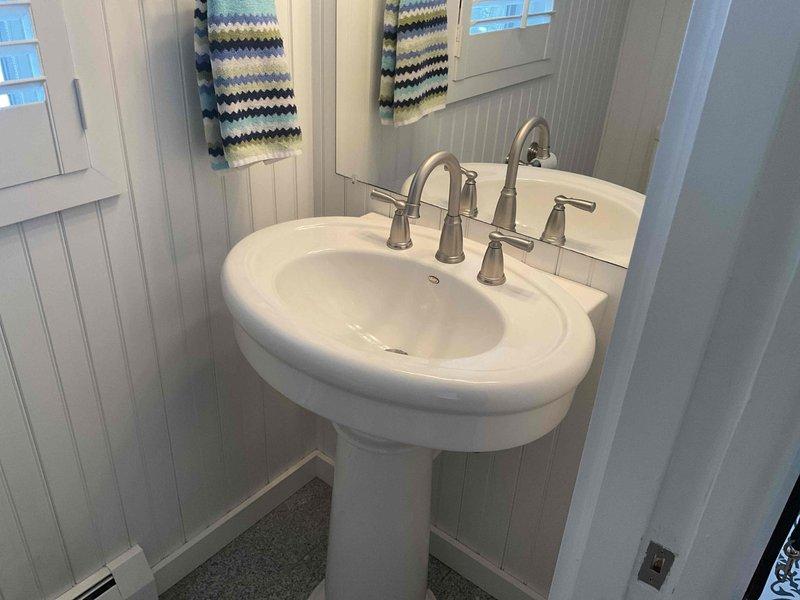 Successfully installed customer-supplied dual brushed nickel faucets on a white pedestal sink in bathroom. Completed installation with proper water connections and verified functionality before departure. Final inspection confirmed no leaks and proper operation of the new fixture.