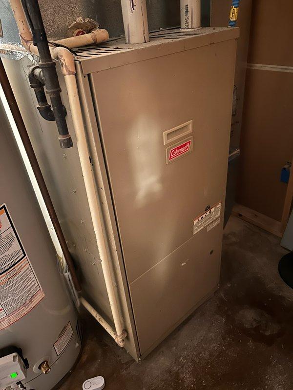 Diagnosed Coleman furnace with no heat issue; found locked inducer motor and cracked collector box screw points causing system failure. Successfully freed the inducer motor to restore temporary operation and provided estimates for collector box replacement and other recommended repairs. Also noted water heater flue cap had blown off with resulting rust damage.