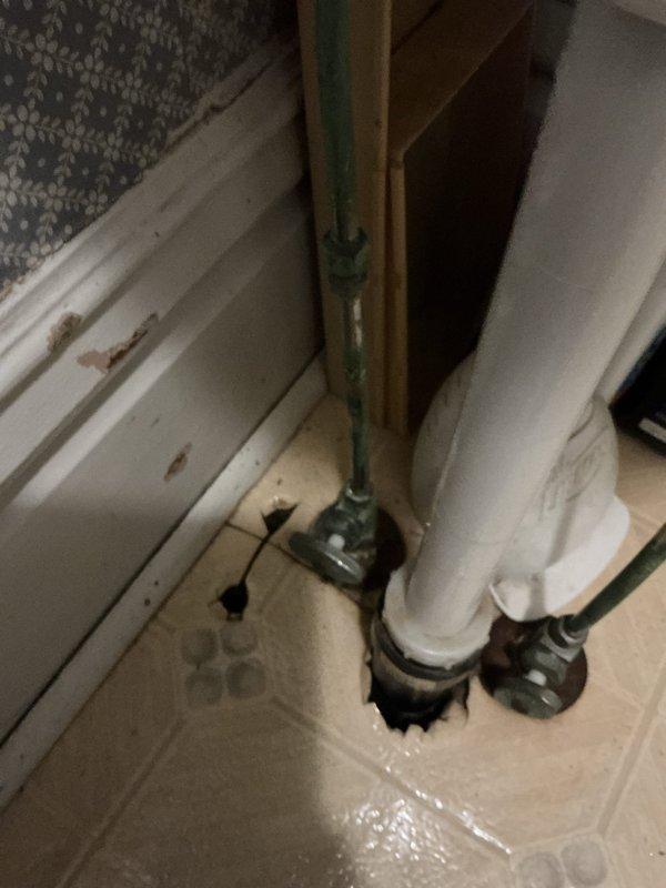 Completed replacement of deteriorated toilet, addressing significant water damage around the floor drain. Identified and rectified leaking compression nut on stop valve by replacing the toilet fixture and properly tightening the supply line connection to ensure proper water flow and prevent future leakage.