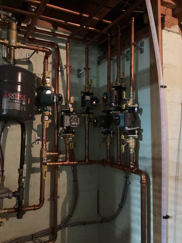 Performed annual maintenance on residential heating system, which included cleaning the flame sensor on the FRP boiler (installed 2 years ago), verifying proper operation of all heating zones, and inspecting the heat exchanger which appeared in good condition. Drained and cleaned the condensate trap, checked system pressure, and confirmed all components were functioning correctly. Visual inspection of the comprehensive copper piping network, expansion tank, and associated valves showed the installation to be in good working order.