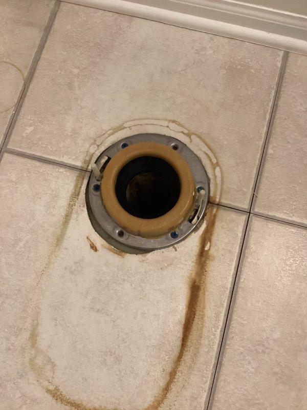 Responded to service call for toilet leakage issue identified during home inspection. Upon assessment, discovered deteriorated toilet flange with significant water damage to surrounding tile. Removed toilet, replaced broken flange, installed new wax ring, and reset toilet properly to eliminate leak and restore proper functionality.