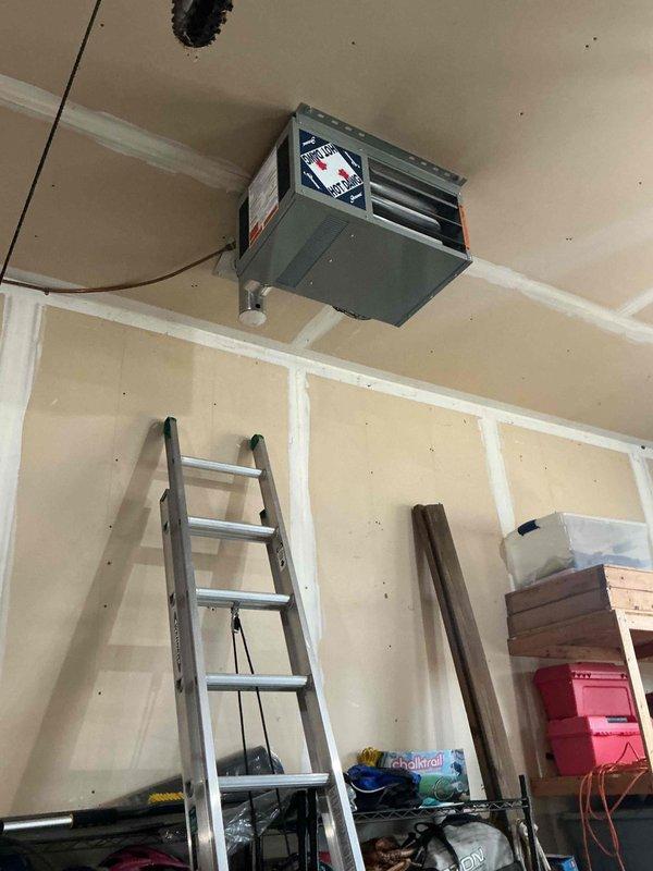 Diagnosed inoperative 24-year-old Hot Dawg garage heater. Confirmed control board failure preventing fan operation during heating cycle. Parts order submitted; return visit scheduled with appropriate ladder equipment to complete installation of replacement board.