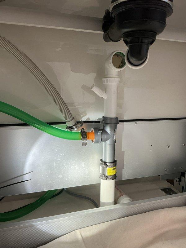 Completed installation of faucets in the second floor bathroom sink, including proper P-trap assembly and drainage connections. Successfully installed and connected all required PVC piping with appropriate metal clamps and secured the flexible drain hose system. All connections were verified for proper function with no leaks observed.