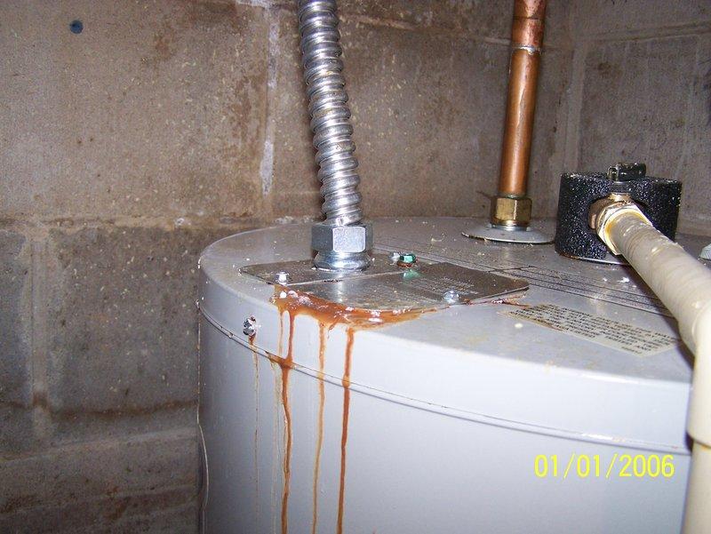 Responded to service call for water heater leaking from top connections. Diagnosed significant corrosion and rust streaking down tank side originating from upper fittings. Removed failed 50-gallon electric water heater and installed new replacement unit with proper connections to existing plumbing system.