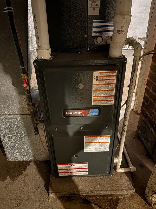 Responded to no heat call for 24-year-old Hurlburt furnace that failed to ignite. Diagnosed plugged pressure switch port as primary issue; cleaned port and restored system operation. Performed inspection of heat exchanger with no defects found, but noted significant rust formation on burners which may require replacement in near future. Discussed potential system replacement options with customer due to unit's advanced age.