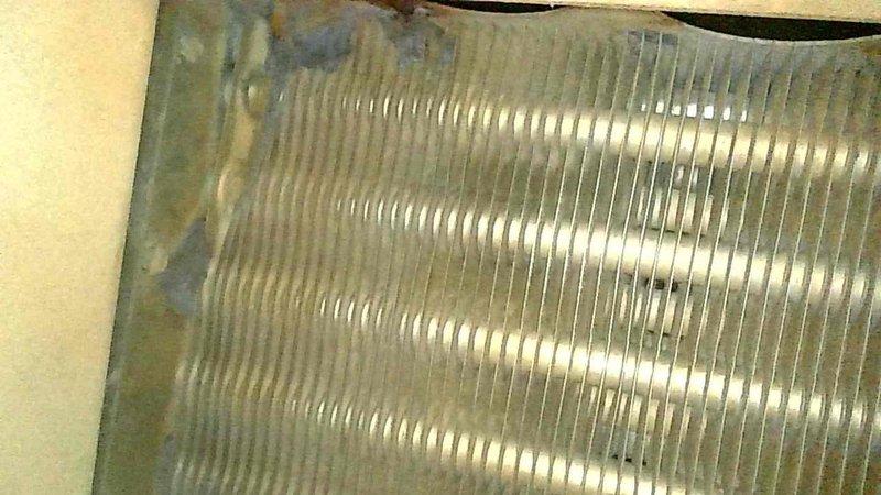Performed maintenance on 14-year-old gas furnace that was tripping on high limit due to plugged filter. Discovered blower wheel has play and rough startup, with capacitors reading below specifications (15μF cap reading 13μF and weak inducer capacitor). Inspected heat exchanger with no immediate compromises but noted areas of concern, and observed evidence of evaporator pan leakage and potential refrigerant leak. After installing clean filter, verified proper system operation with acceptable temperatures and gas pressures during 15-minute test run. Recommended future inspection of heat exchanger and professional evaluation due to age and condition of system.