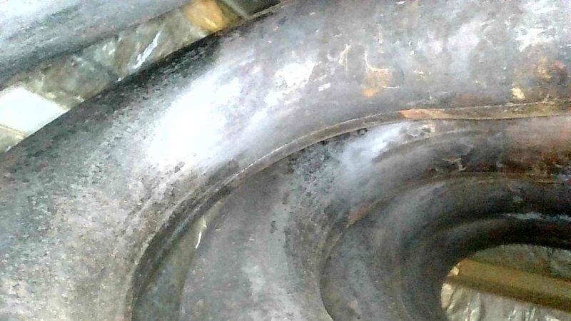 Performed maintenance on 14-year-old gas furnace that was tripping on high limit due to plugged filter. Discovered blower wheel has play and rough startup, with capacitors reading below specifications (15μF cap reading 13μF and weak inducer capacitor). Inspected heat exchanger with no immediate compromises but noted areas of concern, and observed evidence of evaporator pan leakage and potential refrigerant leak. After installing clean filter, verified proper system operation with acceptable temperatures and gas pressures during 15-minute test run. Recommended future inspection of heat exchanger and professional evaluation due to age and condition of system.