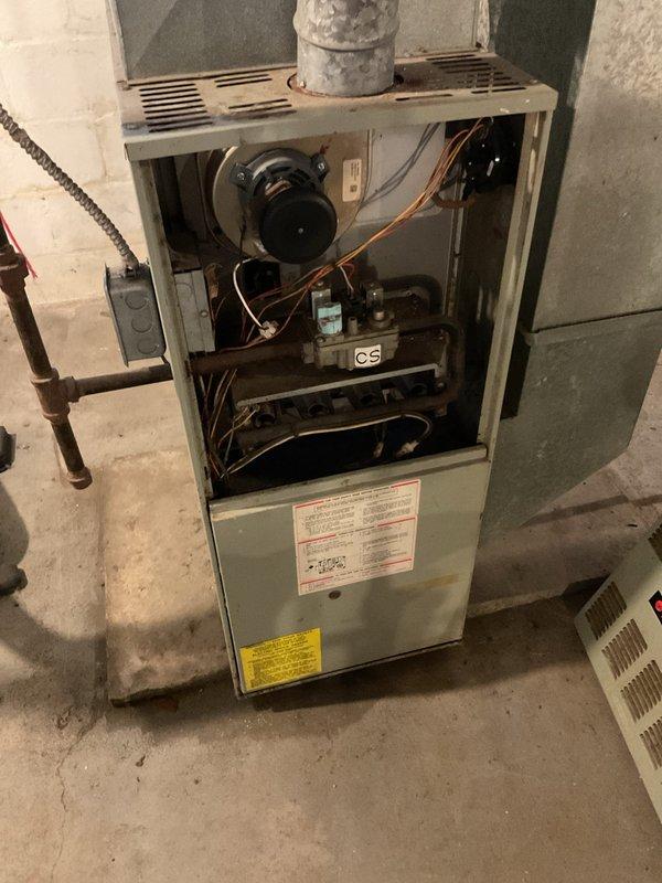 Performed furnace tune-up on 1995 Trane 80% efficient natural gas furnace that replaced previous oil furnace. Conducted thorough inspection including heat exchanger evaluation with no crimp cracks detected and carbon monoxide testing showing 0 ppm after 10+ minutes of operation. Homeowners plan to replace both furnace and chimney in the future.
