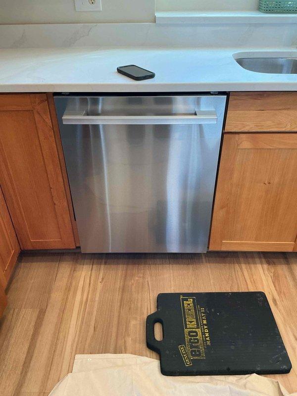 Replaced non-functional dishwasher shut-off valve located under the sink and completed installation of customer-supplied dishwasher. Connected water supply line with new shut-off, secured drain hose, and performed leak check to verify proper operation and drainage.