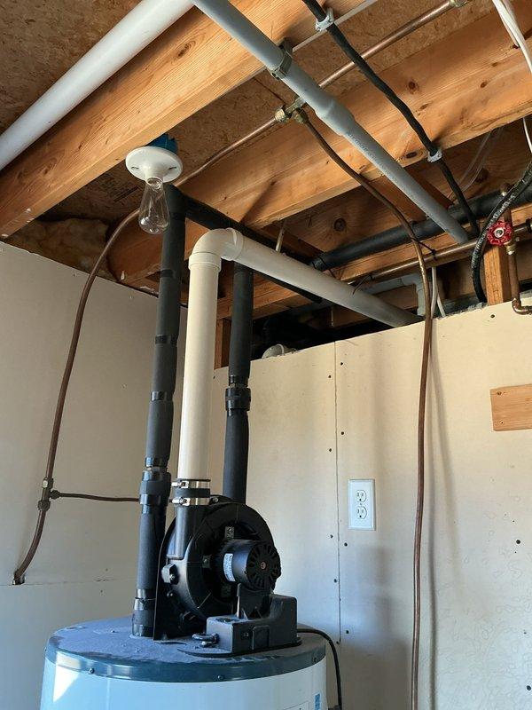 Responded to emergency service call for a 50-gallon Richmond power-vented water heater (natural gas/propane) that was not functioning. Diagnostic inspection revealed water leaking onto the burner assembly, preventing proper ignition. Provided customer with replacement options for both standard tank and tankless water heater systems.