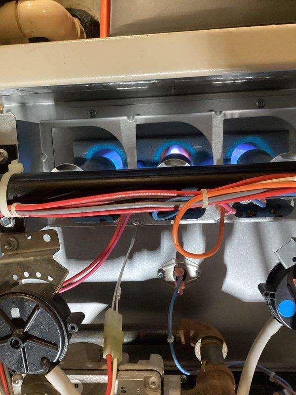 Responded to emergency no-heat call for furnace failure. Diagnosed multiple issues including tripped rollout switch, severely clogged condensate drain with insect debris, and compromised secondary heat exchanger with visible holes and cracks. Reset rollout switch temporarily restoring operation, but due to safety concerns with the cracked heat exchanger, tagged unit out of service. Recommended complete furnace replacement based on age and condition of equipment. Scheduled follow-up consultation for replacement options.