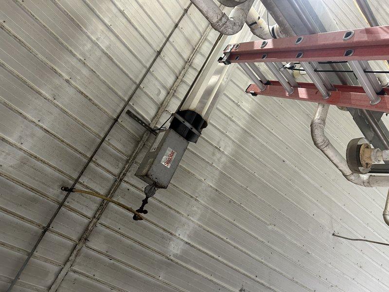 Responded to no-heat service call for LP tube heater in milking parlor. Diagnosed unit but was unable to complete service due to inadequate ladder access height for ceiling-mounted equipment. Service will be rescheduled with appropriate A-frame ladder to safely perform the necessary repairs.