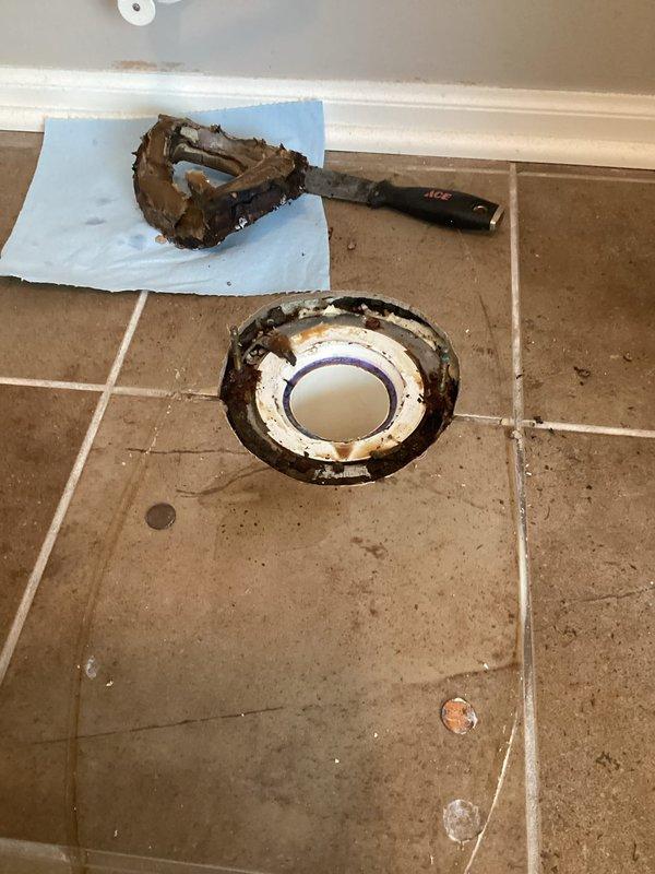 Responded to water leak complaint where water was penetrating through kitchen ceiling from upstairs bathroom. Diagnosis revealed an improperly installed toilet flange that was positioned too low. Removed toilet, built up the flange to proper height, and reset toilet which successfully resolved the leak issue.