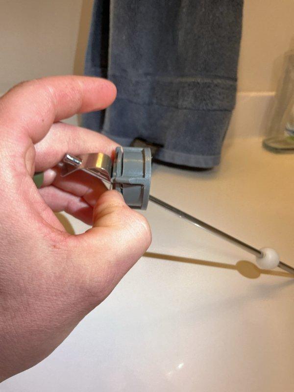 Diagnosed and identified two separate leaks: a cracked pivot rod assembly causing water leak beneath bathroom sink and a faulty hose attachment under laundry sink. Provided customer with repair estimates for both issues, noting that hard water conditions are likely contributing to multiple faucet failures throughout the home. Customer will decide on proceeding with recommended repairs after consultation with spouse.