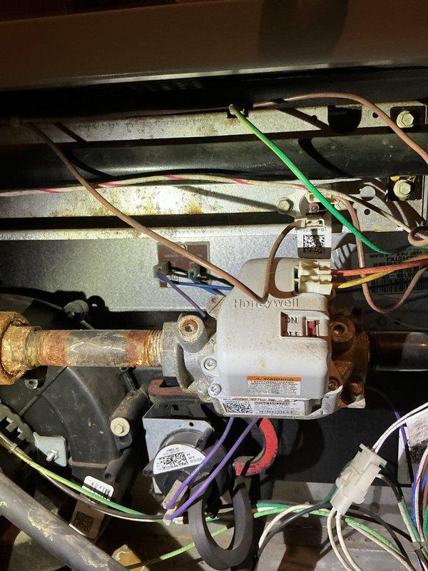 Performed non-member tune-up on 16-year-old gas furnace. System inspection revealed significant dust accumulation on air filter requiring replacement and notable corrosion on copper gas line connections at the Honeywell valve. Customer has maintained regular service intervals, previously addressing inducer leak and replacing blower as needed.