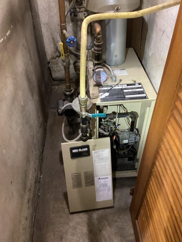 Responded to no heat call for Weil-McLain LP boiler system. Diagnosed issue as interrupted gas supply to boiler causing pilot light outage. Re-lit pilot light, verified proper operation of both zone thermostats, and confirmed all components were functioning correctly. Provided homeowner with instructions on proper pilot light relighting procedure for future reference.