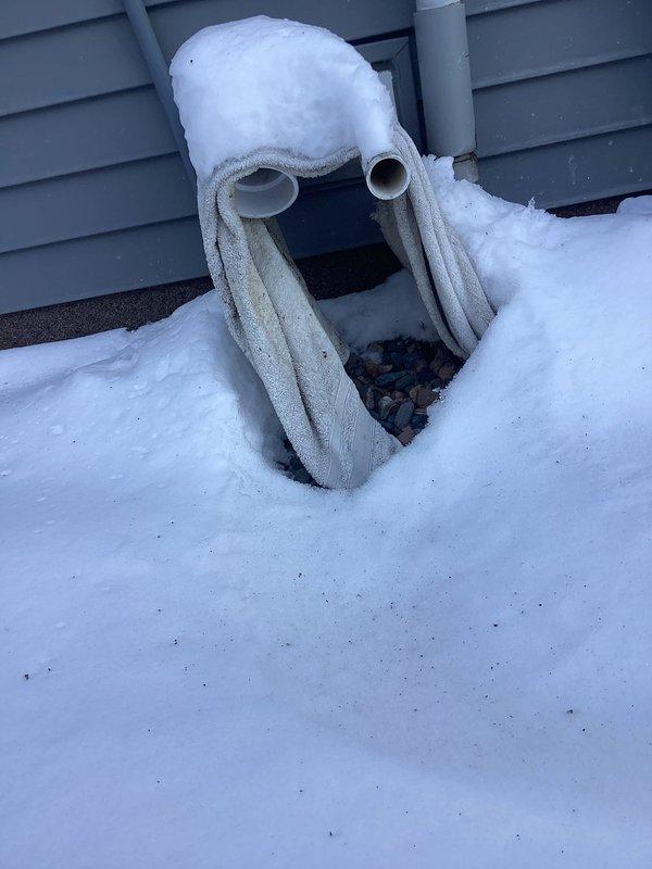 Responded to no-heat call for 5-year-old HVAC system with customer reporting 7 blink error code and cold air only. Diagnostic inspection revealed an open roll out switch triggered by snow-blocked exhaust vents. Cleared substantial snow accumulation from PVC intake and exhaust pipes, which had caused improper combustion and safety shutdown. System restored to normal operation after ventilation was properly established.