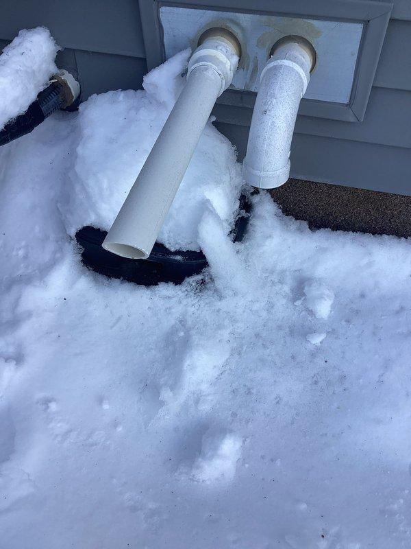 Responded to no-heat call for 5-year-old HVAC system with customer reporting 7 blink error code and cold air only. Diagnostic inspection revealed an open roll out switch triggered by snow-blocked exhaust vents. Cleared substantial snow accumulation from PVC intake and exhaust pipes, which had caused improper combustion and safety shutdown. System restored to normal operation after ventilation was properly established.
