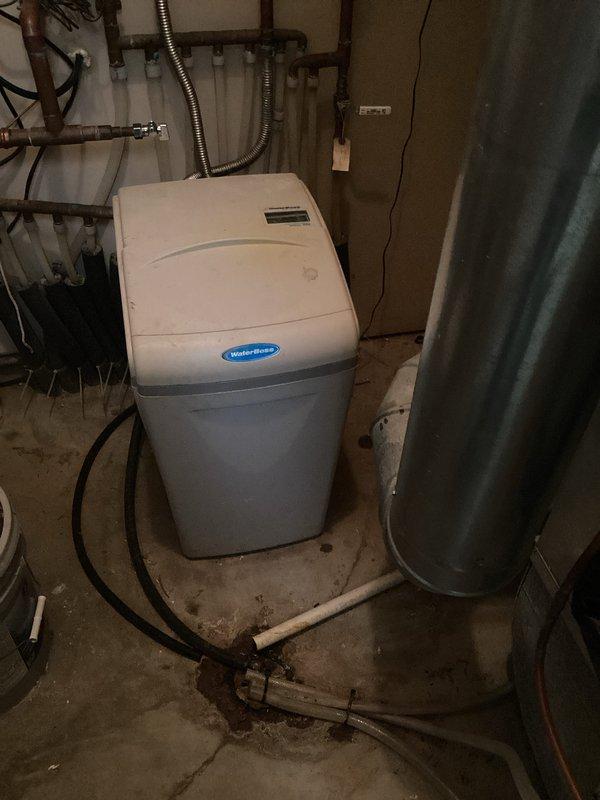 Completed installation of new garbage disposal unit in kitchen sink. Performed comprehensive Family Rewards plumbing inspection, which included examination of under-sink plumbing connections and water treatment system (Water-Boss unit). Documented condition of existing plumbing infrastructure with photos for service records.