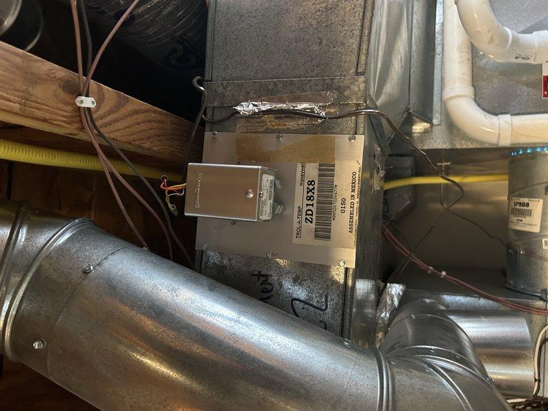 Diagnosed whistling and banging noises originating from a binding zone damper for the main floor that is not opening properly when activated. Determined that replacement of the problematic damper requires significant ductwork removal due to its location behind existing ductwork. Recommended replacement of both zone dampers as a preventative measure since they are of the same age.
