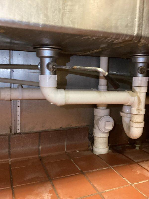 Responded to water leak call at commercial property with three-compartment sink issue. Diagnosed the problem as a leaking 1/2" PEX-B ball valve located under the sink near the restroom. Successfully replaced the defective ball valve, resolving the leak and restoring proper functionality to the plumbing system.
