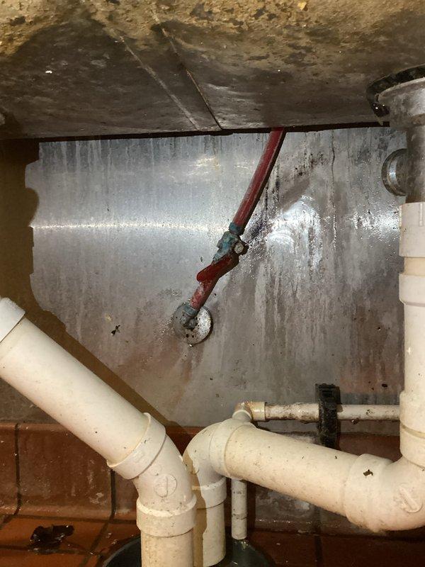 Responded to water leak call at commercial property with three-compartment sink issue. Diagnosed the problem as a leaking 1/2" PEX-B ball valve located under the sink near the restroom. Successfully replaced the defective ball valve, resolving the leak and restoring proper functionality to the plumbing system.