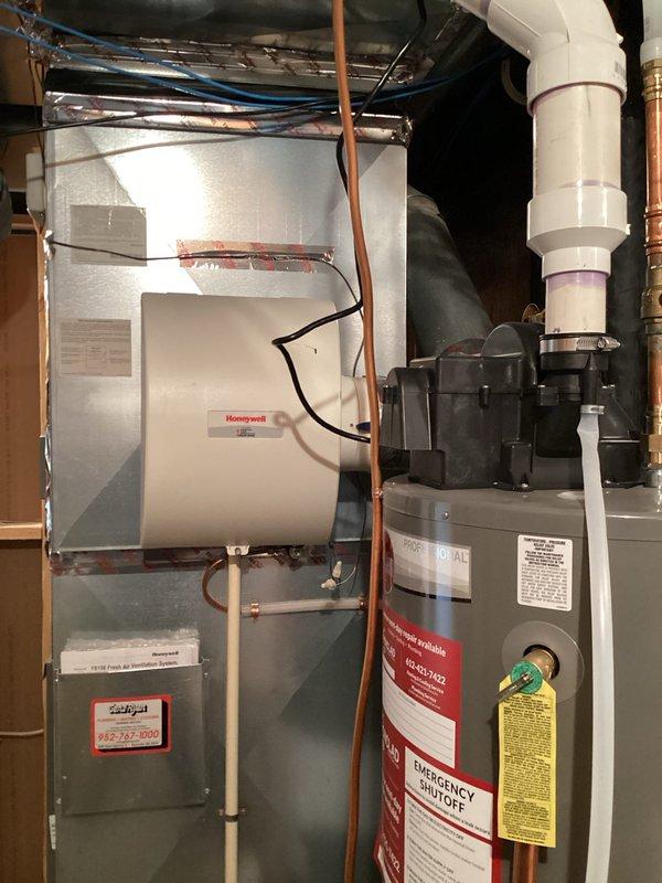 Diagnosed 15-year-old natural gas furnace with intermittent operation issue where thermostat was not triggering furnace activation during temperature drops. Inspection of control board revealed voltage drop to inducer motor, preventing proper startup sequence. Documented condition of control board connections and overall system installation for service advisor recommendation.
