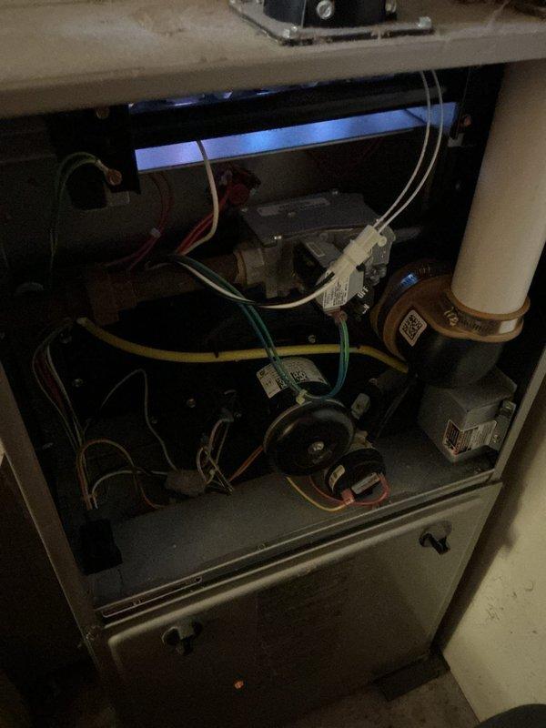 Responded to call for furnace not cycling on properly, resulting in intermittent heat. Diagnosed and cleaned dirty flame sensor, which restored proper operation with good micro amp readings. Noted two non-operational zone motor dampers with upstairs damper partially closed and unable to manually open, potentially causing furnace overheating; advised client that replacement or removal of dampers may be necessary if issue persists.