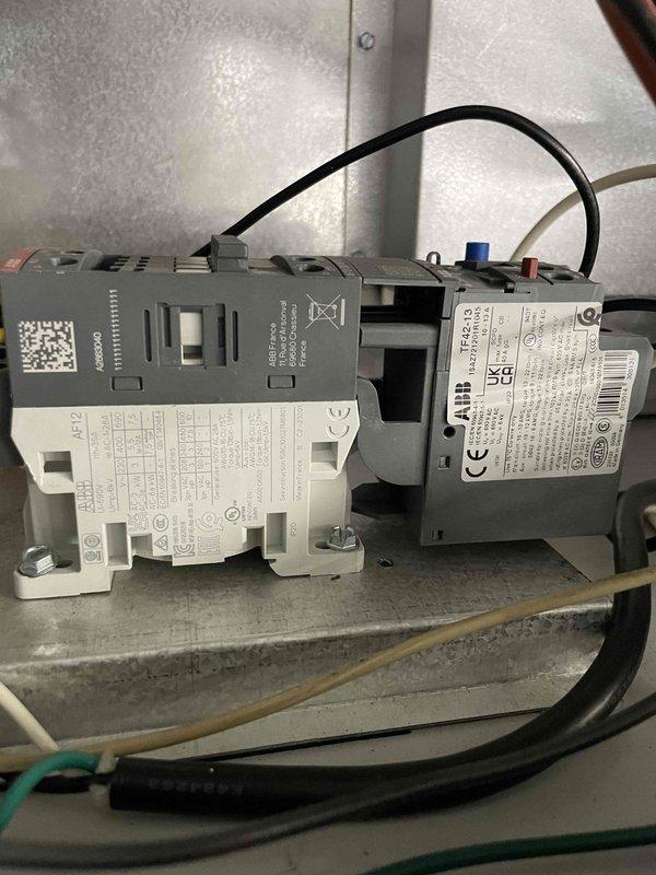 Responded to service call for ducted unit heater in inspection bay with non-functioning blower. Diagnosed tripped overload on blower motor, reset and tested operation. Motor drawing 9.7A during operation, which is within acceptable range. System operational after reset, though time constraints prevented full diagnostic testing of capacitors and external overload components.