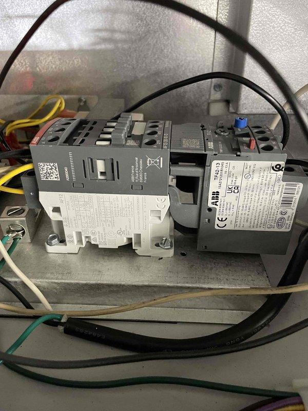 Responded to service call for ducted unit heater in inspection bay with non-functioning blower. Diagnosed tripped overload on blower motor, reset and tested operation. Motor drawing 9.7A during operation, which is within acceptable range. System operational after reset, though time constraints prevented full diagnostic testing of capacitors and external overload components.