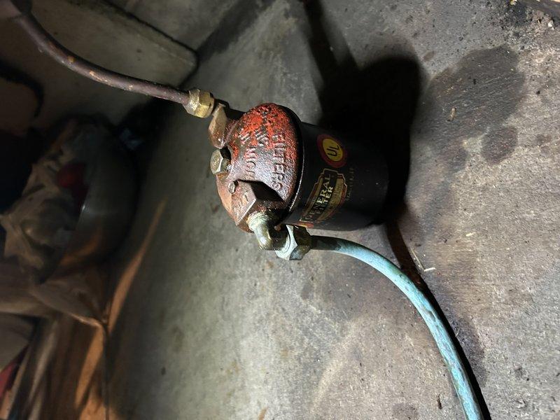 Responded to no-heat service call for aging oil furnace that had run out of fuel. Diagnosed air in the fuel line after customer attempted to add diesel fuel. Performed maintenance including replacement of oil filter and nozzle, then bled air from the fuel line to restore proper ignition. System was successfully restored to operation prior to scheduled oil delivery. Noted deteriorated filter housing with old gasket that could not be removed; reused existing gasket and advised customer to monitor for potential leaks as housing may require replacement.