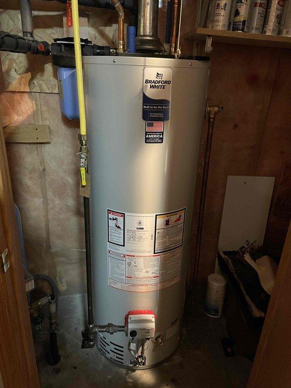 Performed annual furnace tune-up on approximately one-year-old unit. Conducted complete preventive maintenance inspection with all components testing within specifications. System was clean with no operational issues identified. Documentation includes photos of Bradford White water heater installation and electrical service panel.