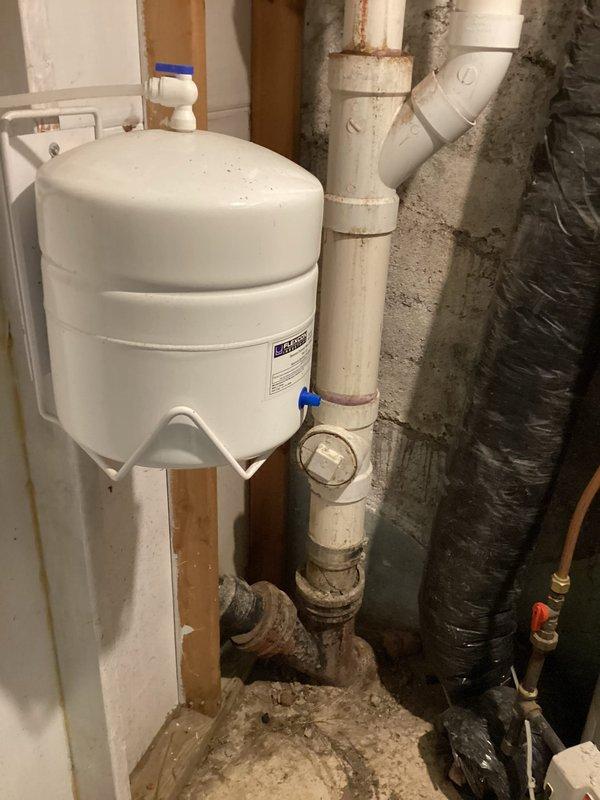Completed measurement and preparation work for sewer liner installation. Accessed existing plumbing system, cut sections as required, and took final measurements to ensure proper liner specifications. Photos documented the current system configuration including expansion tank mounting and PVC pipe connections prior to liner installation.