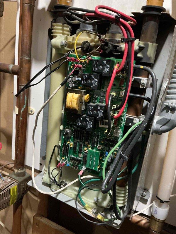 Diagnosed 21-year-old electric boiler failure in radiant in-floor heating system, finding control board relay arced with multiple fried components, likely due to failed heating element. Determined replacement parts unavailable as boiler model is discontinued. Scheduled comfort advisor appointment to discuss replacement options.