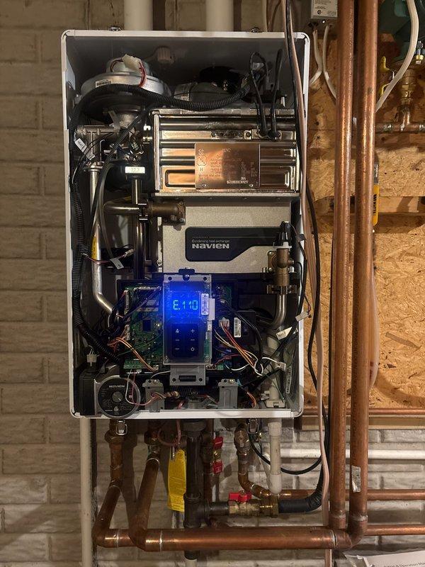 Responded to no hot water complaint on a Navien tankless water heater system showing error code E.140. Diagnostic inspection revealed a condensate plug preventing proper operation. Successfully cleared the blockage in the condensate line, restoring full functionality to the unit. System tested and confirmed proper operation before completing service.
