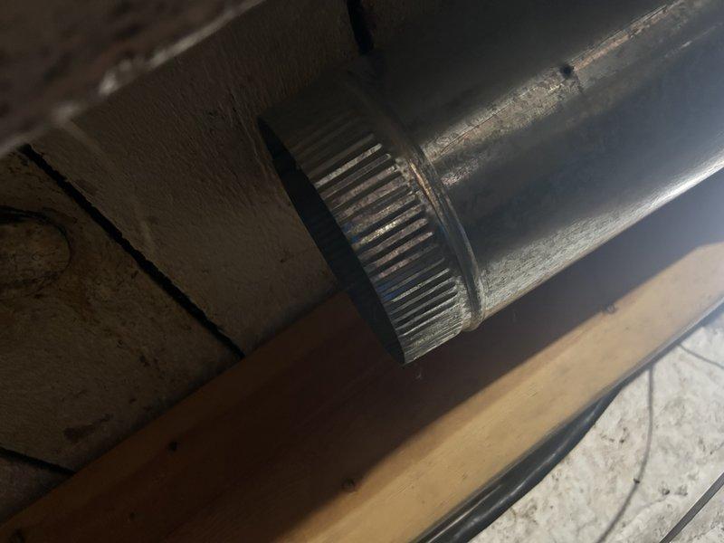 Inspected disconnected 8-inch insulated flex duct in underfloor area that had been damaged by rodents. Assessed approximately 12 feet of ductwork requiring replacement, with visible holes and separation at connection points. Documented condition with photographs showing the deteriorated metal ductwork in the crawlspace environment.