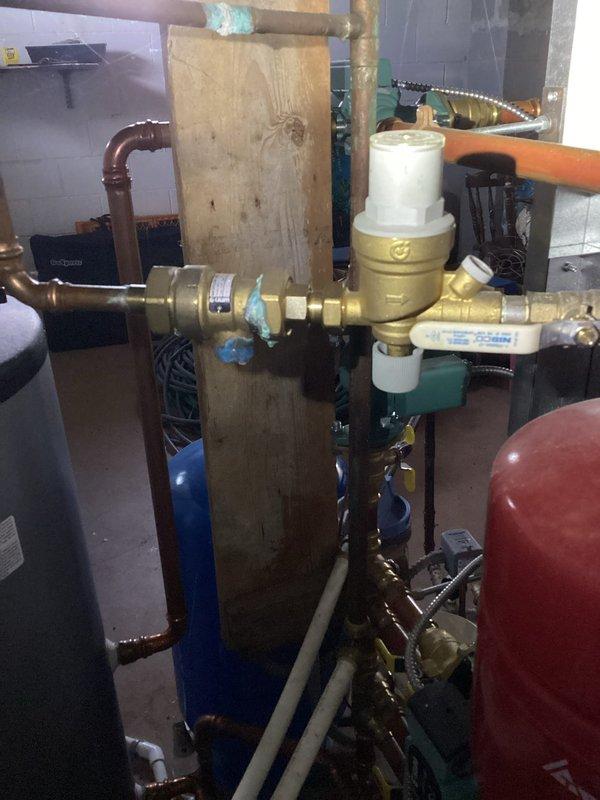 Performed annual boiler tune-up service including cleaning the flame sensor and flushing the condensate trap. Inspection revealed the heat exchanger is in acceptable condition and all boiler settings are properly configured. Discovered and documented a leaking backflow preventer relief valve, provided estimate for repair and initiated warranty investigation as unit was installed approximately two years ago.