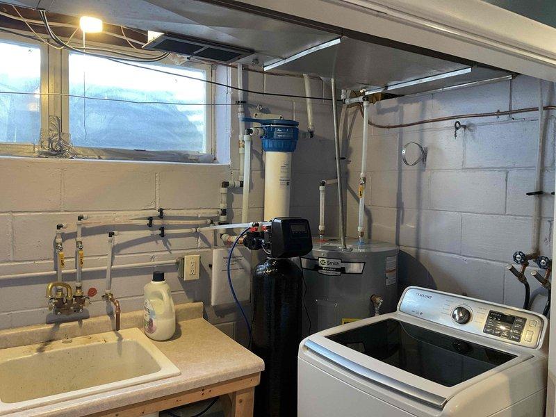Successfully adjusted 3/4" PEX tubing and fittings in basement utility area to accommodate proper clearance for dryer vent installation following a previous re-pipe service, resolving the interference issue that was preventing proper ventilation setup.