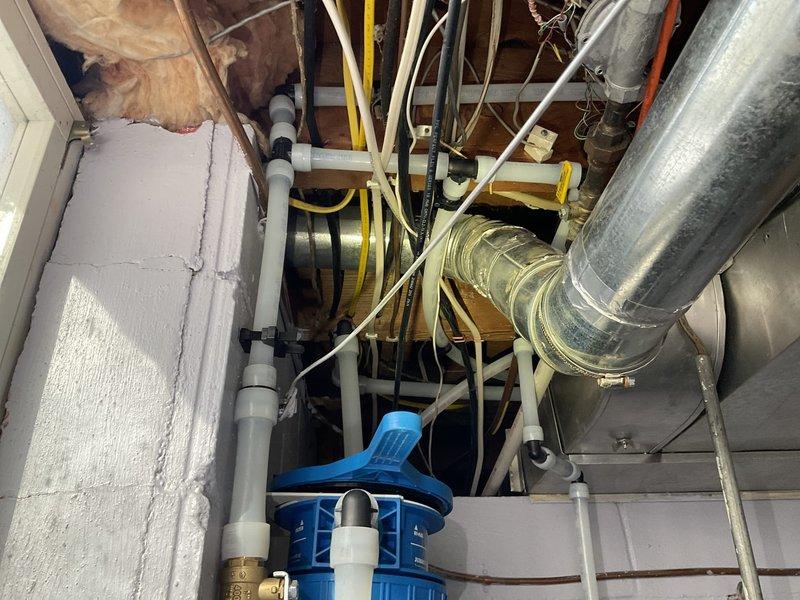 Successfully adjusted 3/4" PEX tubing and fittings in basement utility area to accommodate proper clearance for dryer vent installation following a previous re-pipe service, resolving the interference issue that was preventing proper ventilation setup.