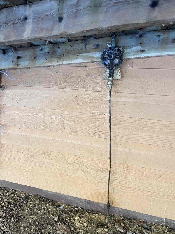 Responded to a gas leak call where the propane copper line had developed a hole before the regulator, causing hissing and gas leakage at the LP tank connection outside the residence. Verified the customer had properly turned off the furnace and water heater as safety precaution. Customer was advised to contact their gas company for necessary repairs, which was scheduled for same-day service.