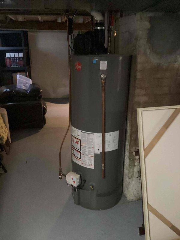 # Service Summary

Responded to no hot water complaint with GFCI outlet tripping issue. Diagnosed electric water heater with faulty heating element causing electrical short, resulting in GFCI trips and warm outlet condition. Due to age of unit and cost-effectiveness of repair versus replacement, recommended water heater replacement to customer.

# Work Performed

Arrived on-site and confirmed no hot water available and GFCI outlet repeatedly tripping when reset. Inspected residential electric water heater located in basement utility area. Verified no visible leaks present at tank, connections, or temperature/pressure relief valve. Tested GFCI outlet and confirmed tripping behavior, noting outlet temperature elevation indicating electrical draw issue.

De-energized circuit at breaker panel and removed water heater access panels to inspect internal electrical components. Tested both upper and lower heating elements with multimeter. Identified lower heating element showing signs of failur