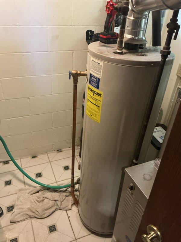 # Service Report: Water Heater Replacement

Successfully completed installation of a new 40-gallon residential water heater in utility room. Removed existing water heater and installed replacement unit, connecting all copper supply lines with brass fittings and ensuring proper integration with existing plumbing infrastructure including water softener system. All connections were secured with appropriate shutoff valves, pressure relief valve was properly installed, and unit was tested for proper operation and leak-free performance upon completion.